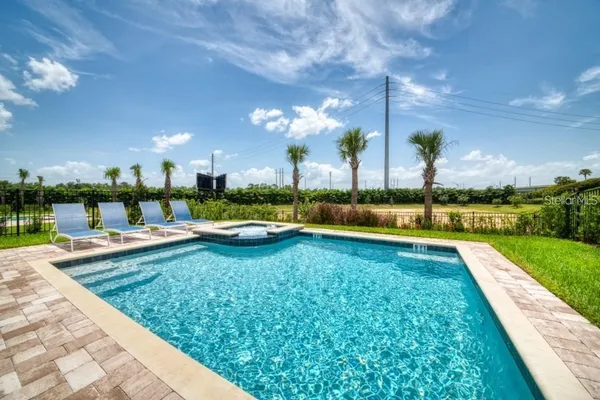 a view of a backyard with swimming pool