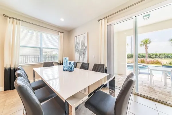 a view of a dining room with furniture large windows and wooden floor