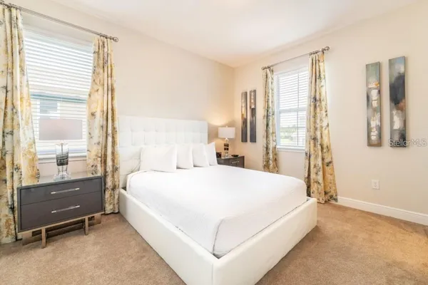 a bedroom with a bed and large window