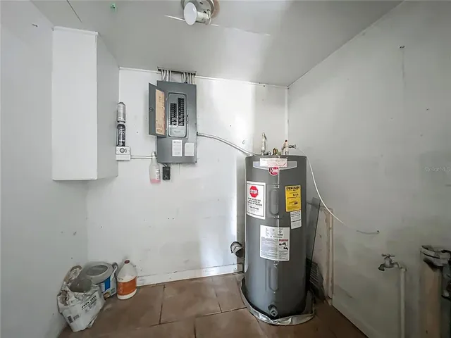 a room with water heater and white walls