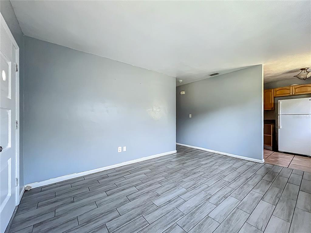 1025 South Central Avenue Lakeland, FL 33815 - Photo 15 of 42 a view of an empty room with wooden floor and a window