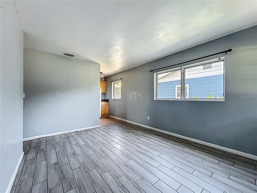 1025 South Central Avenue Lakeland, FL 33815 - Photo 16 of 42 a view of an empty room with wooden floor and a window