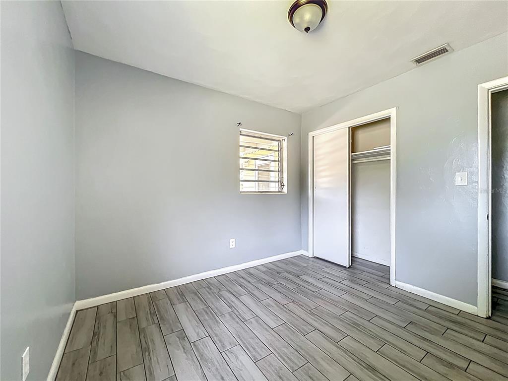 1025 South Central Avenue Lakeland, FL 33815 - Photo 24 of 42 wooden floor in an empty room with a window