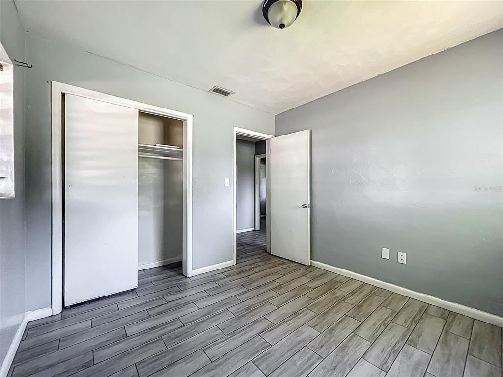 1025 South Central Avenue Lakeland, FL 33815 - Photo 25 of 42 a view of an empty room with wooden floor and closet