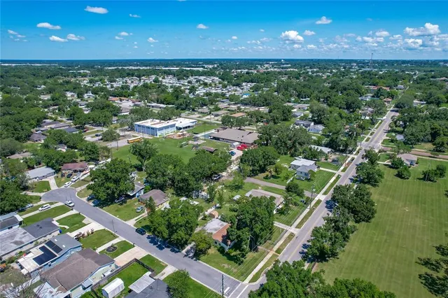 an aerial view of residential houses with outdoor space and street view