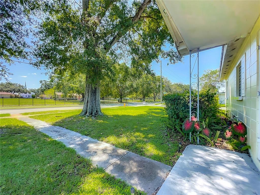 1025 South Central Avenue Lakeland, FL 33815 - Photo 36 of 42 a view of a swimming pool with a garden and trees