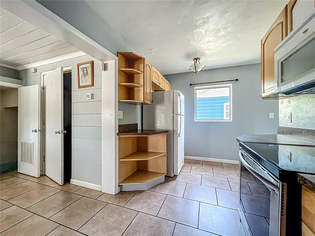 1025 South Central Avenue Lakeland, FL 33815 - Photo 9 of 42 a view of kitchen with stainless steel appliances granite countertop a refrigerator and a stove top oven