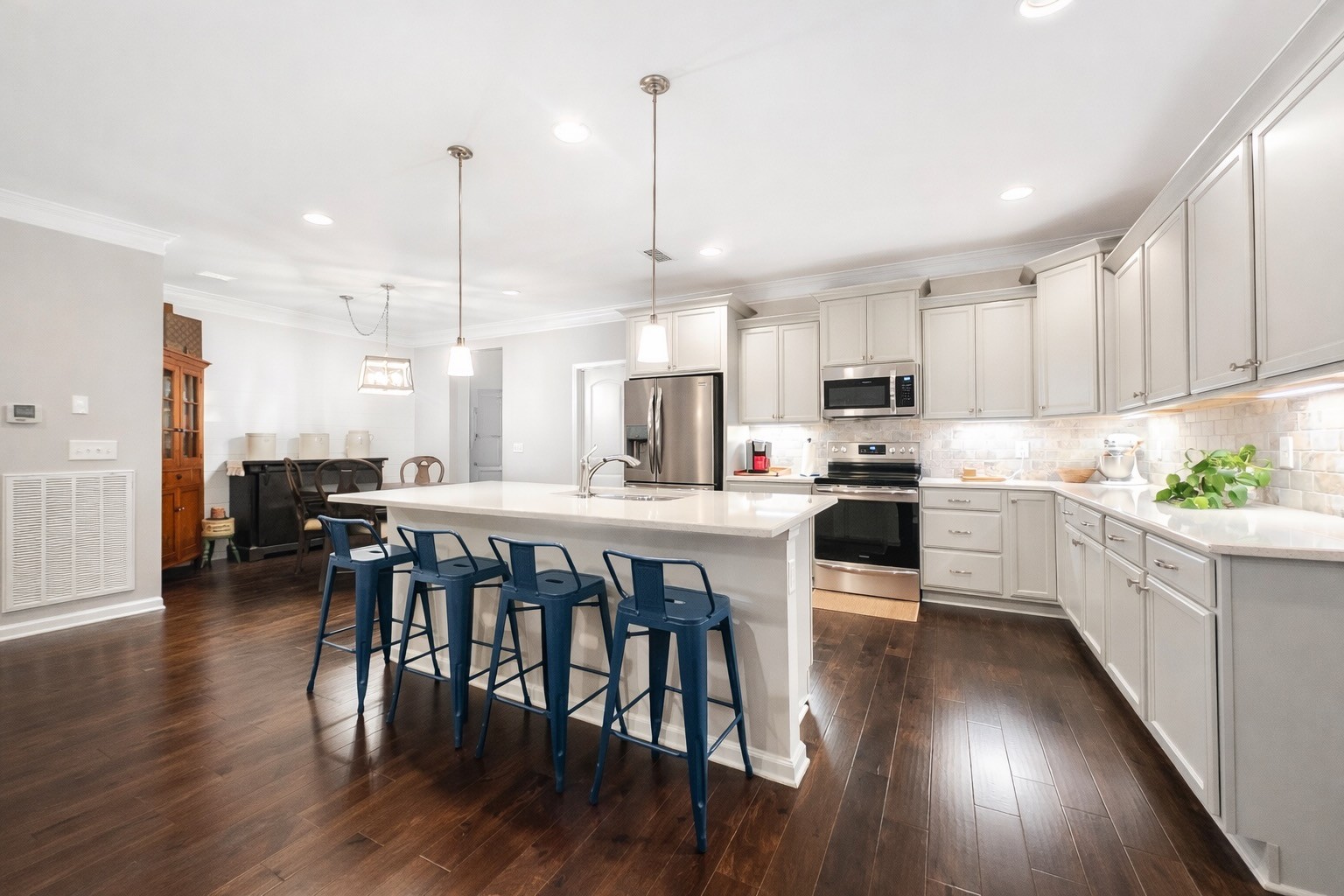 2519 Bridgeway Street Murfreesboro, TN 37128 - Photo 6 of 18 a kitchen with stainless steel appliances granite countertop wooden floors sink and cabinets