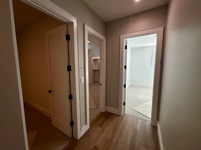 a view of a hallway with wooden floor