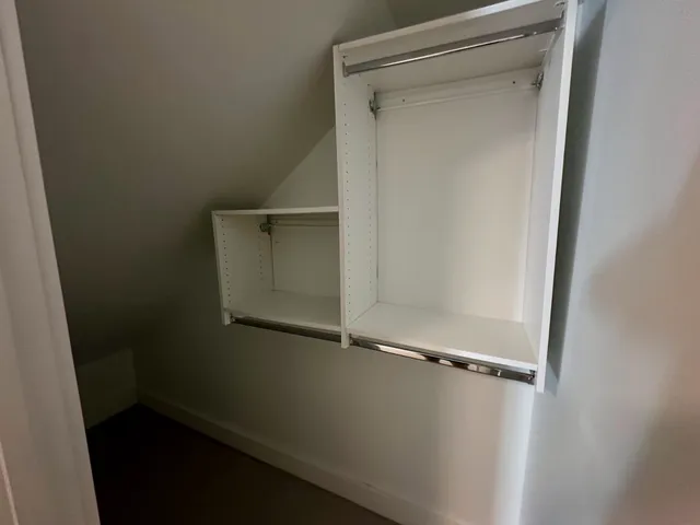 an empty room with wooden floor and sliding door