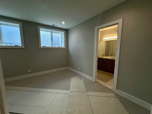 a spacious bathroom with a toilet sink and mirror