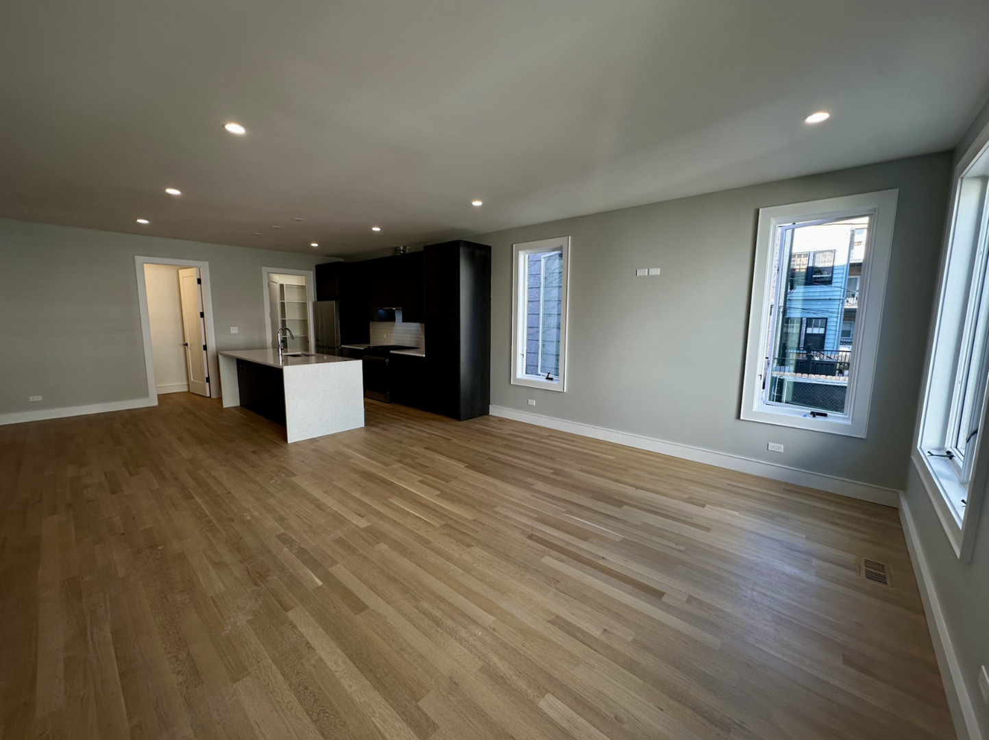 4243 North Damen Avenue, Unit 1R Chicago, IL 60618 - Photo 4 of 38 an empty room with wooden floor and windows