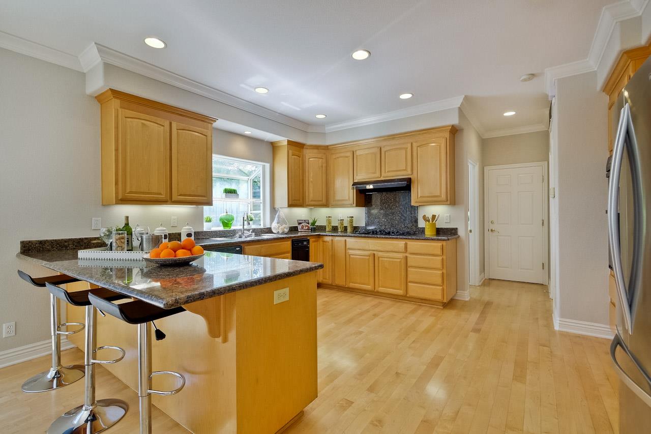 7648 Echo Hill Court Cupertino, CA 95014 - Photo 21 of 50 a kitchen with stainless steel appliances granite countertop a stove a sink a refrigerator and island