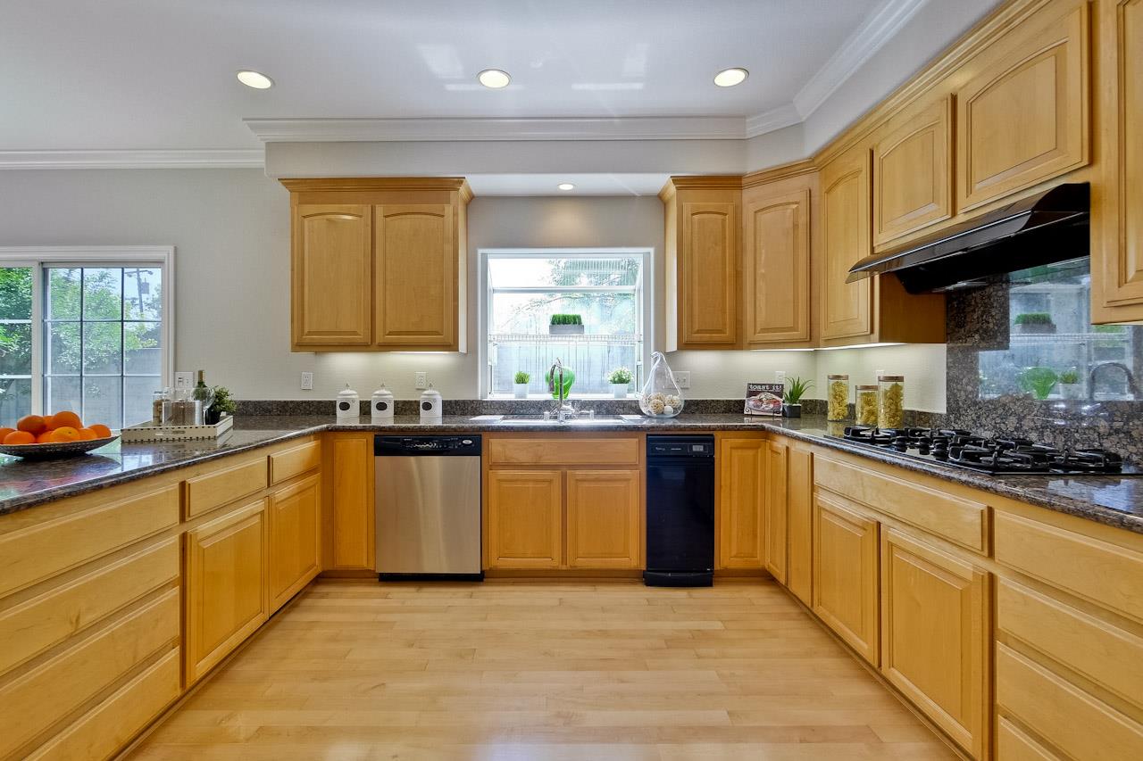 7648 Echo Hill Court Cupertino, CA 95014 - Photo 22 of 50 a kitchen with stainless steel appliances granite countertop wooden cabinets a sink a stove a refrigerator a counter space and cabinets