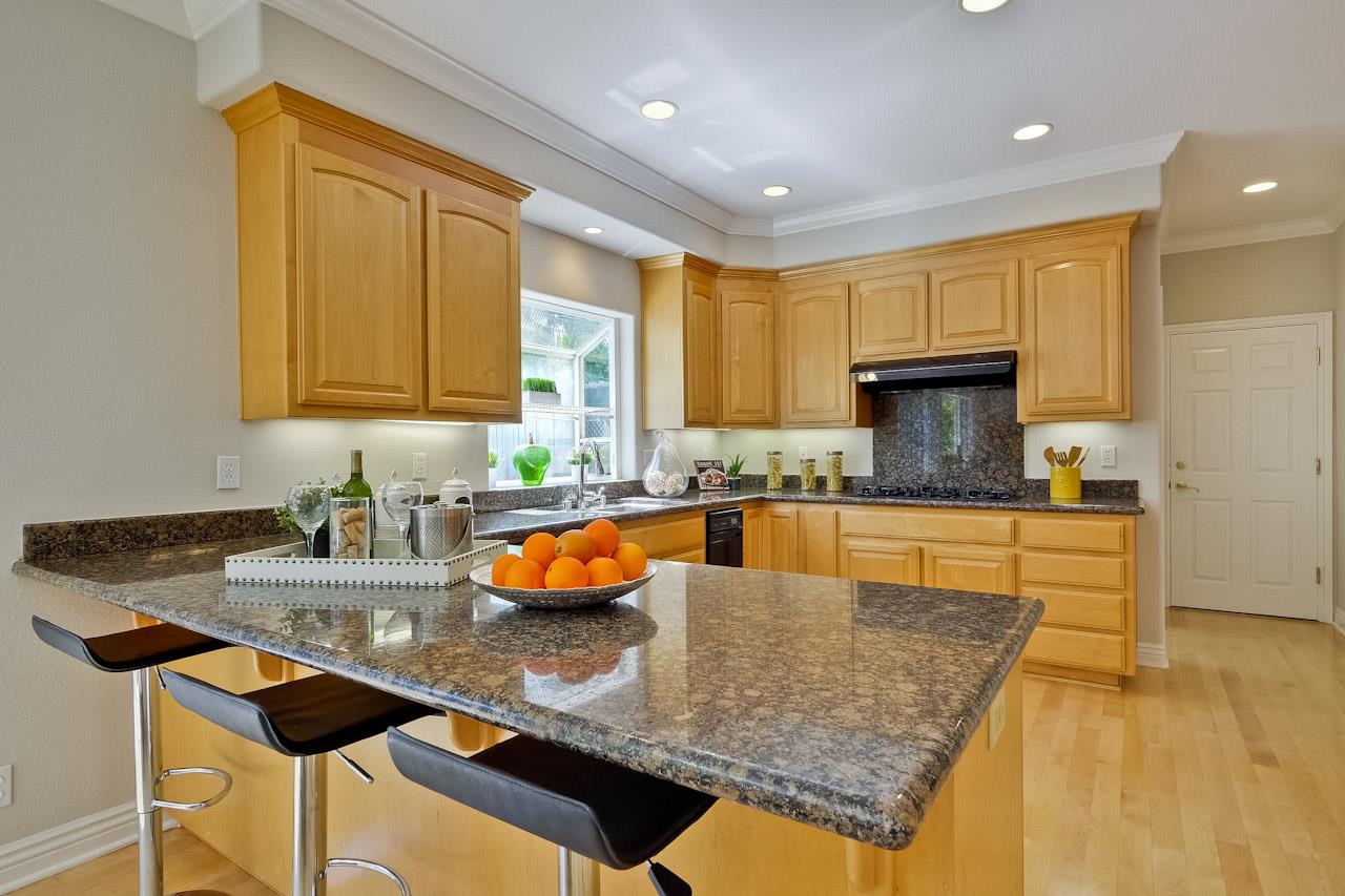 7648 Echo Hill Court Cupertino, CA 95014 - Photo 24 of 50 a kitchen with stainless steel appliances granite countertop a sink stove and cabinets