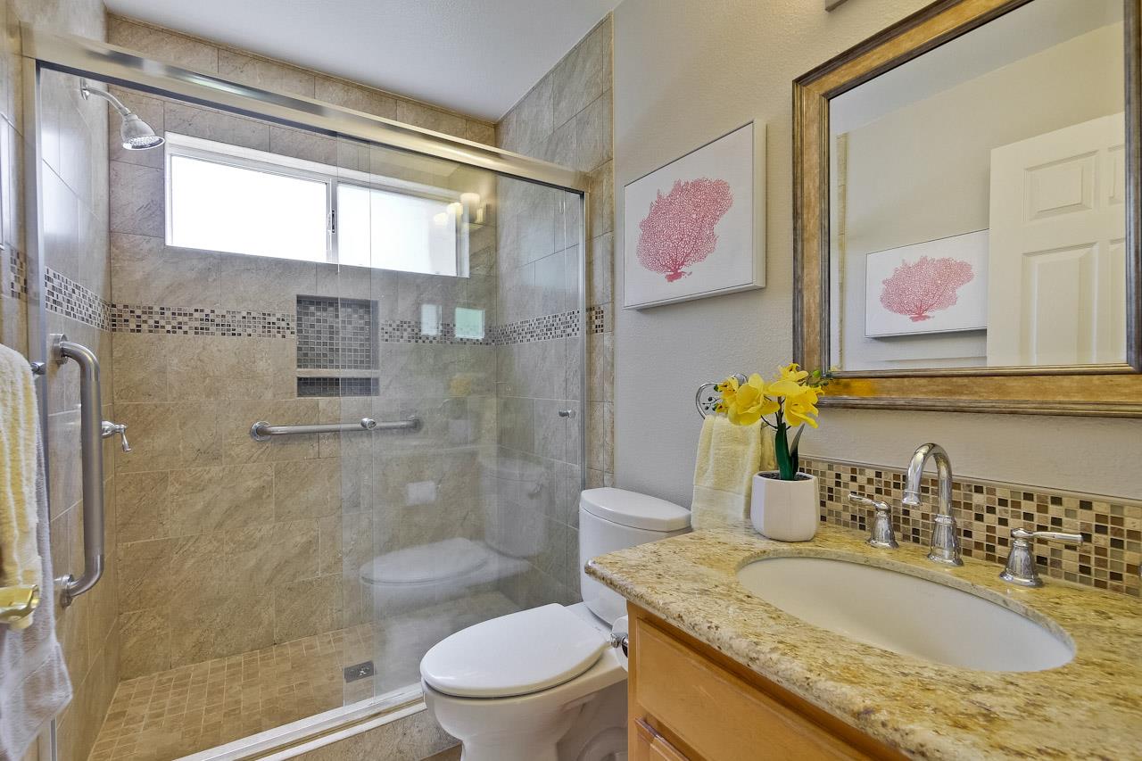 7648 Echo Hill Court Cupertino, CA 95014 - Photo 37 of 50 a bathroom with a granite countertop sink a toilet and shower