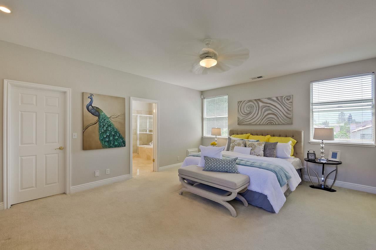 7648 Echo Hill Court Cupertino, CA 95014 - Photo 47 of 50 a spacious bedroom with a bed and a couch