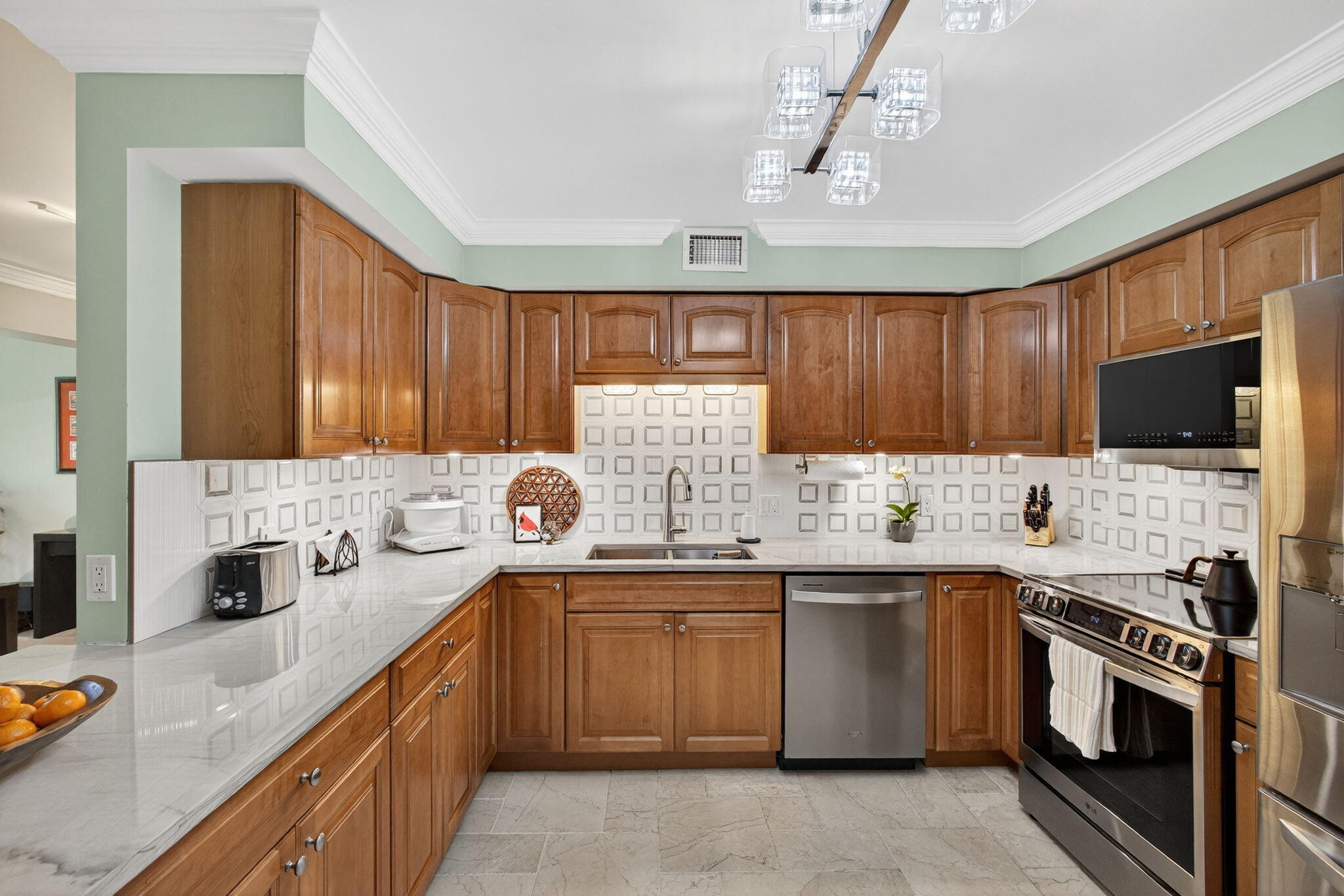 129 South Golfview Road, Unit 7 Lake Worth Beach, FL 33460 - Photo 16 of 79 a kitchen with stainless steel appliances a stove sink microwave and cabinets