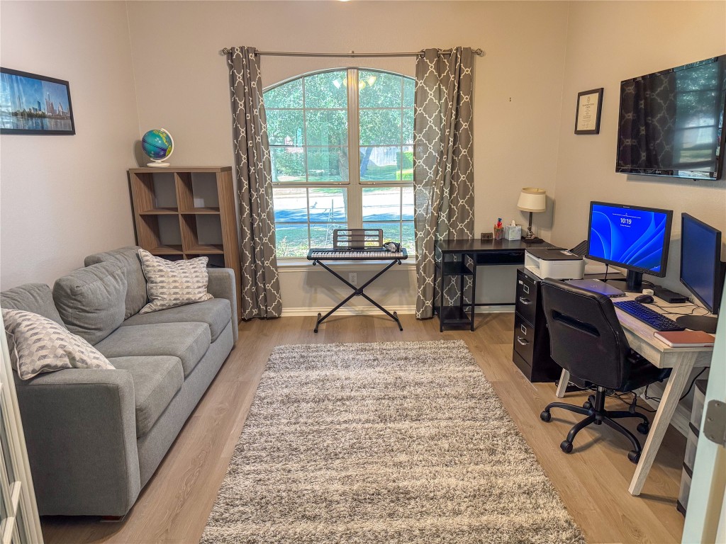 2410 Aspen Meadow Road Leander, TX 78641 - Photo 13 of 24 a living room with furniture a rug and a floor to ceiling window