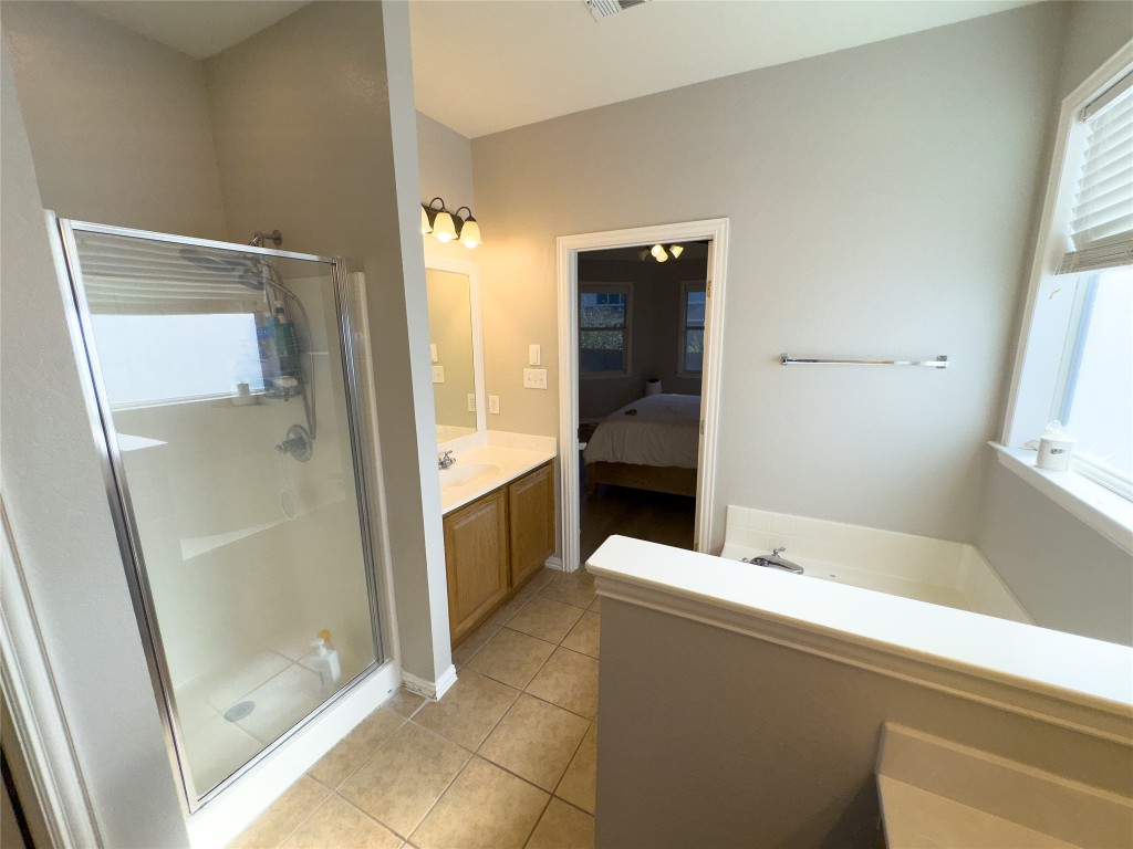 2410 Aspen Meadow Road Leander, TX 78641 - Photo 17 of 24 a bathroom with a tub and shower