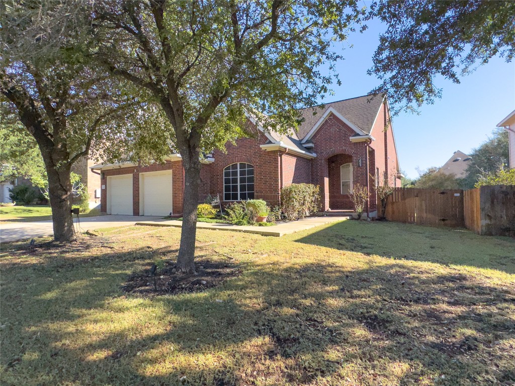 2410 Aspen Meadow Road Leander, TX 78641 - Photo 2 of 24 a house that has a tree in front of it