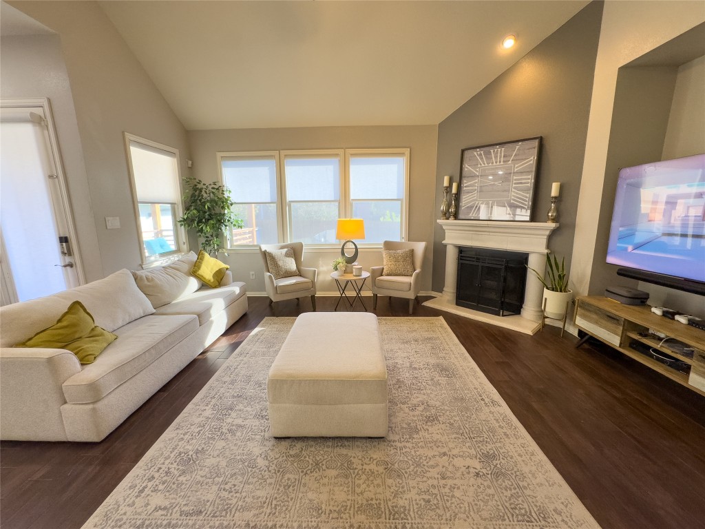 2410 Aspen Meadow Road Leander, TX 78641 - Photo 4 of 24 a living room with furniture flat screen tv and a fireplace