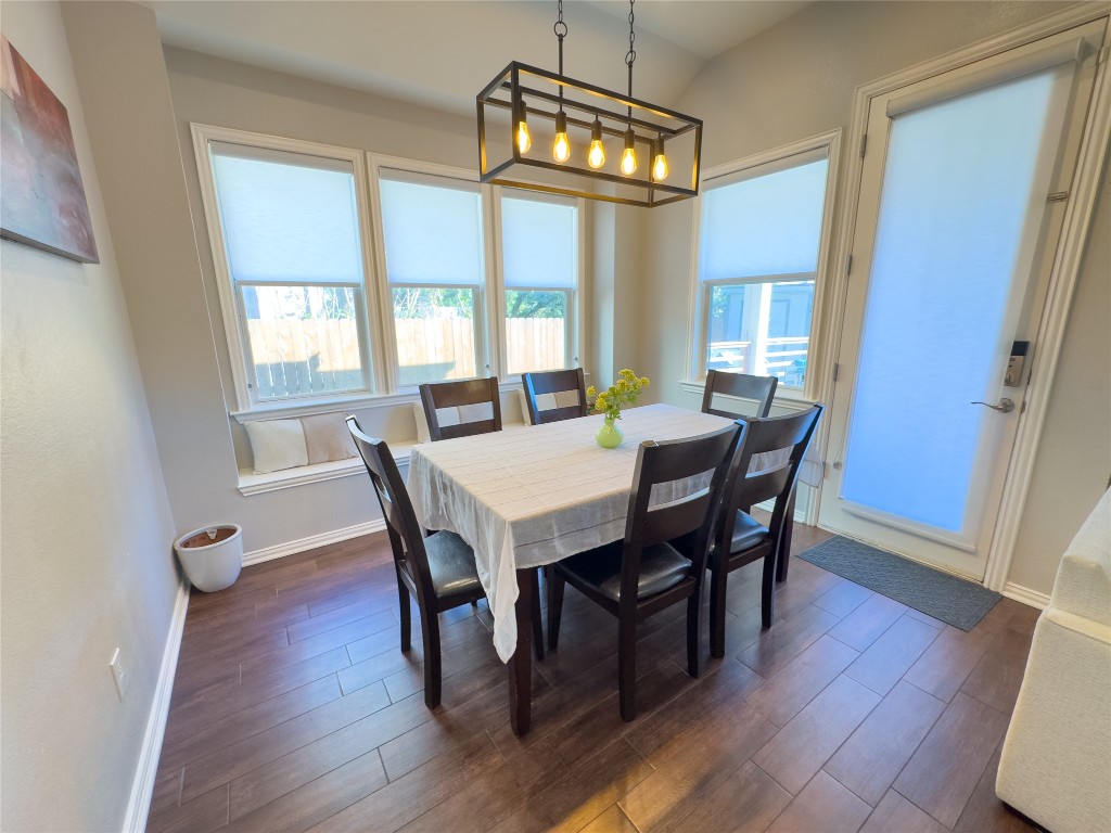 2410 Aspen Meadow Road Leander, TX 78641 - Photo 6 of 24 a view of a dining room with furniture a chandelier and wooden floor