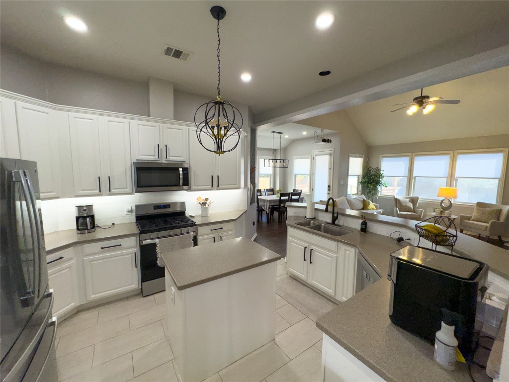 2410 Aspen Meadow Road Leander, TX 78641 - Photo 8 of 24 a kitchen with a sink stainless steel appliances and cabinets