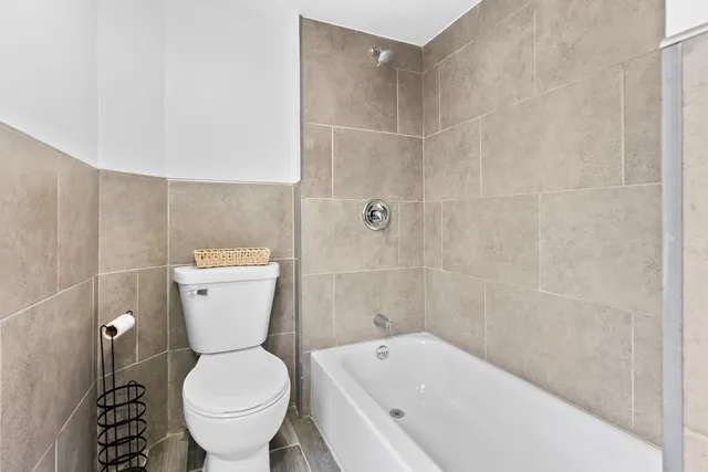 a bathroom with a toilet and a bathtub