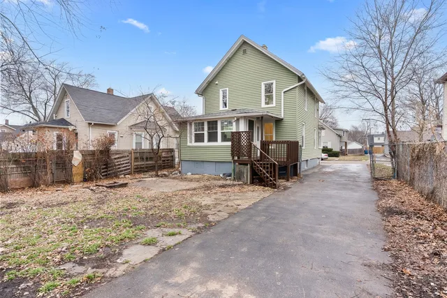 a view of a house with a yard covered in snow