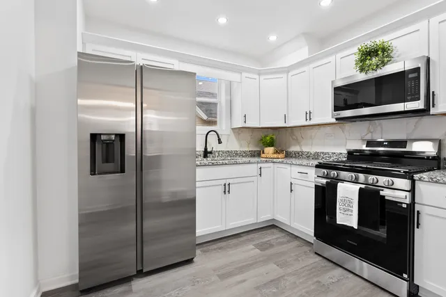 a kitchen with a refrigerator stove and microwave