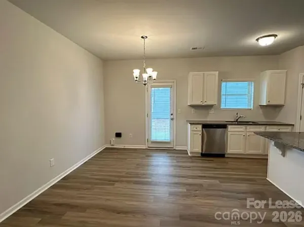 a view of a kitchen with granite countertop cabinets a sink and dishwasher