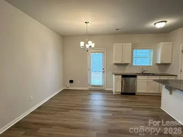 a view of a kitchen with granite countertop cabinets a sink and dishwasher