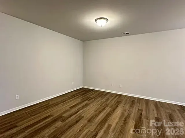 a view of room with wooden floor