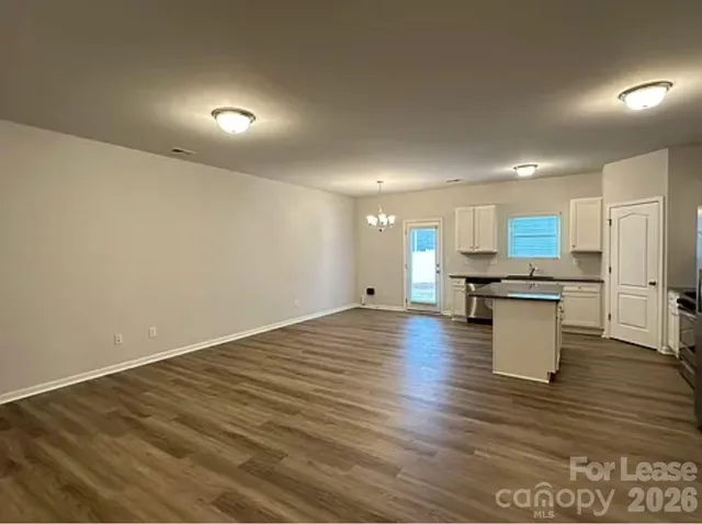 a view of kitchen with cabinets and wooden floor