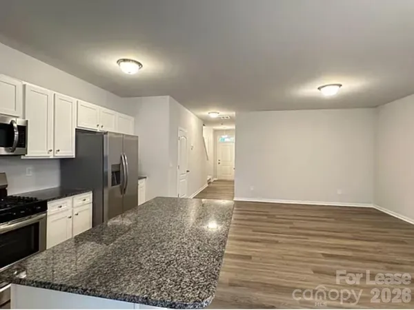 a view of a kitchen with wooden floor