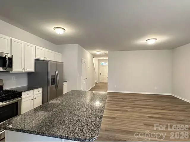 a view of a kitchen with wooden floor