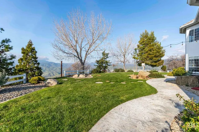 a view of a patio with table and chairs potted plants
