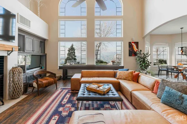 a dining room with furniture a chandelier and wooden floor
