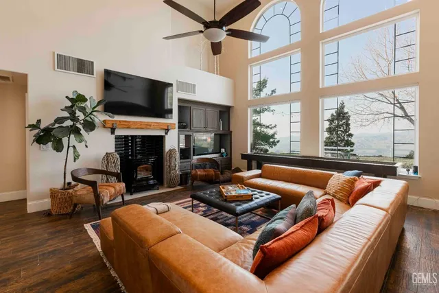 a kitchen with stainless steel appliances granite countertop sink stove and white cabinets with wooden floor