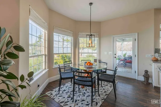 a dining room with furniture and a window