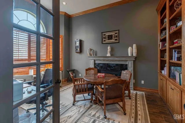 a living room with furniture fireplace and wooden floor