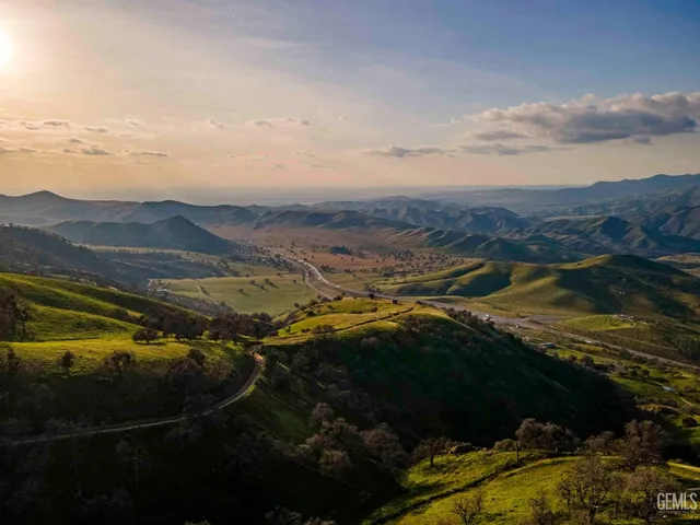 a bedroom with a bed a flat screen tv and a couch