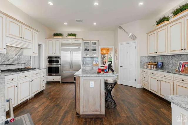 a kitchen with lots of counter top space and dining table