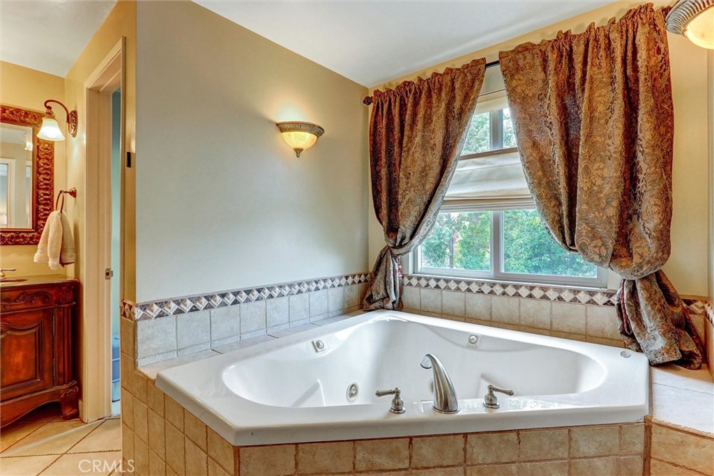 19238 Castlebay Lane Porter Ranch, CA 91326 - Photo 27 of 38 a bathroom with a bathtub and a window