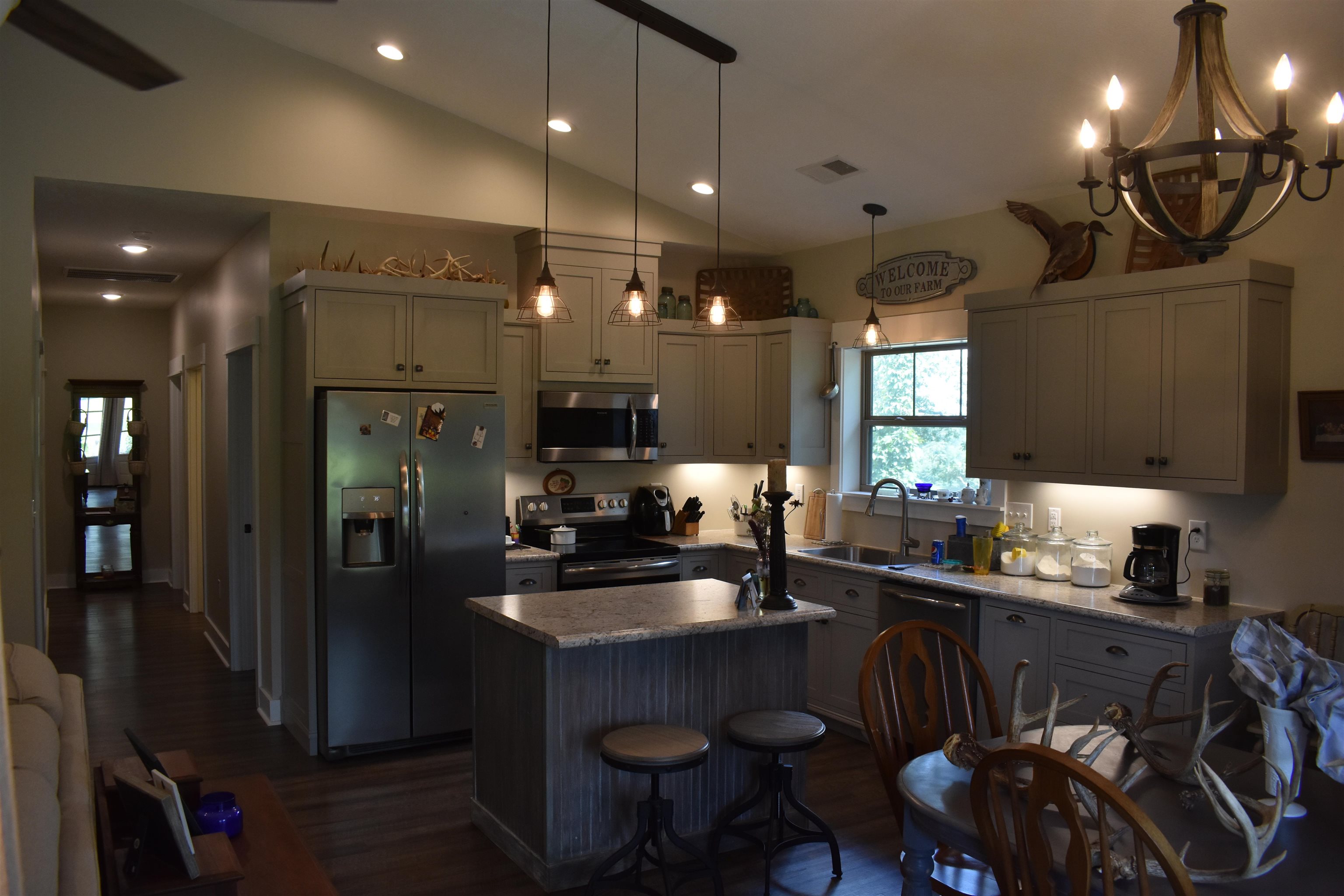 3895 Enville Road Henderson, TN 38340 - Photo 12 of 25 a kitchen with sink a refrigerator and chairs