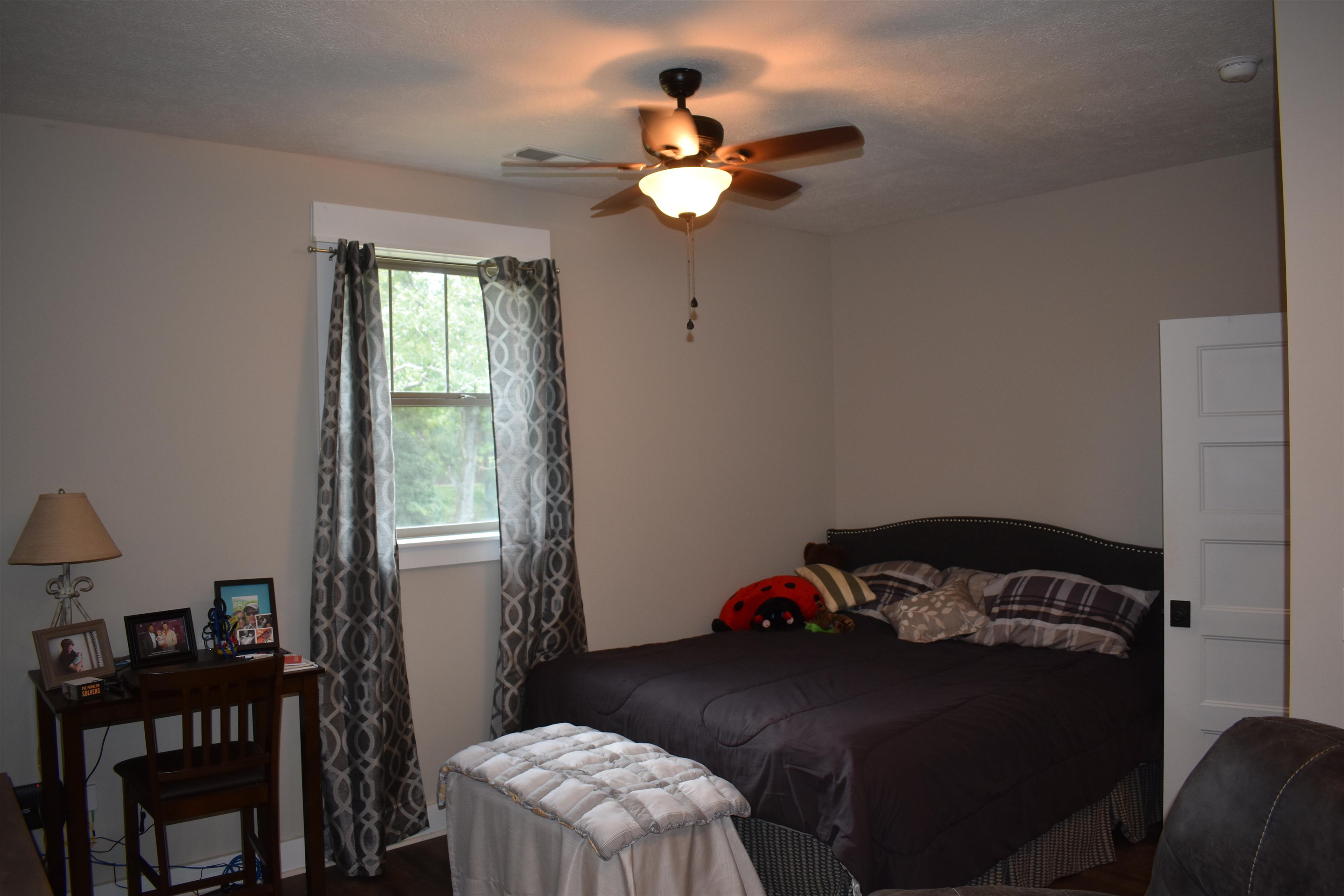 3895 Enville Road Henderson, TN 38340 - Photo 18 of 25 a bedroom with a bed and a chandelier