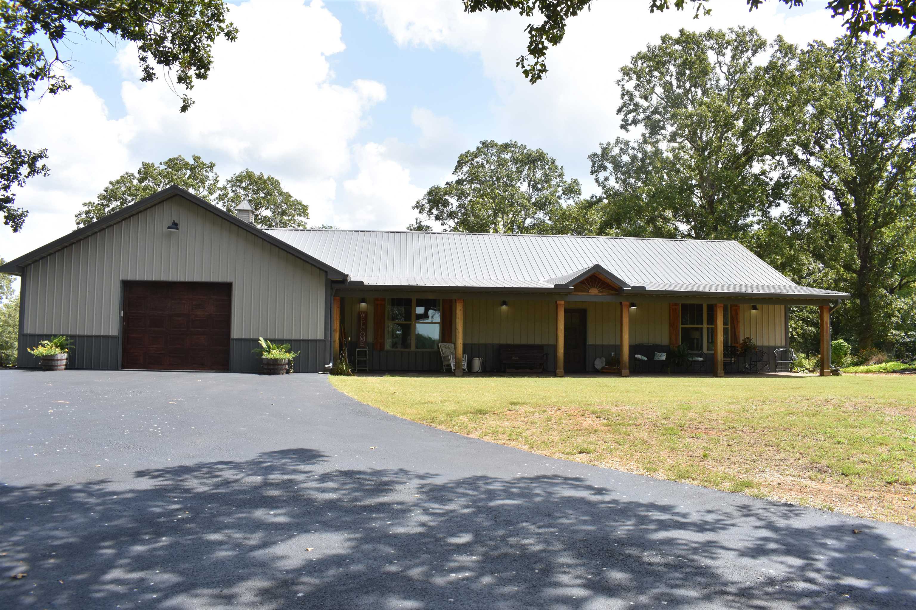 3895 Enville Road Henderson, TN 38340 - Photo 2 of 25 a front view of a house with a yard and garage