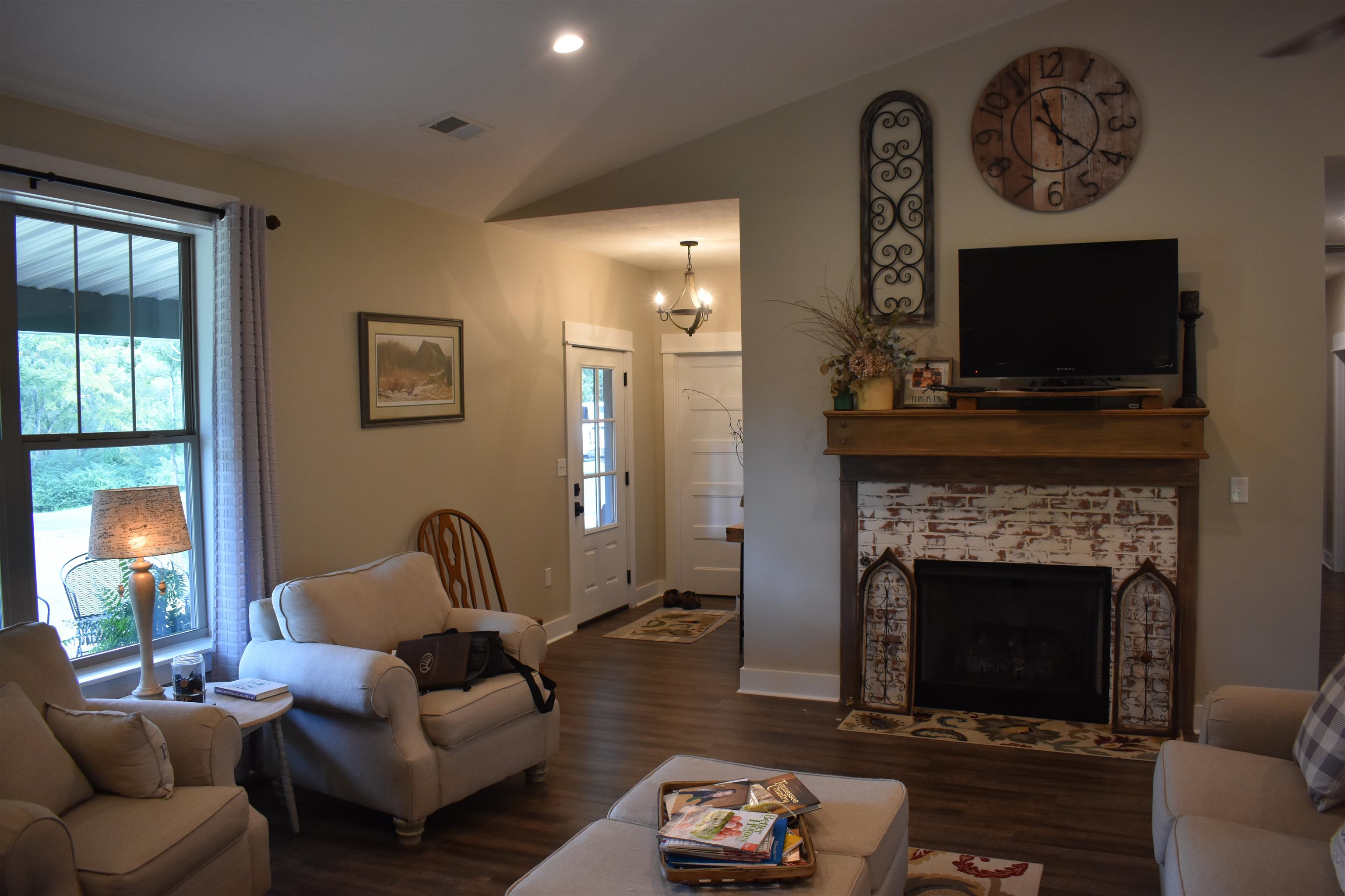 3895 Enville Road Henderson, TN 38340 - Photo 9 of 25 a living room with furniture a flat screen tv and a fireplace