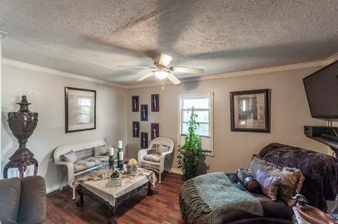 a living room with furniture a window and a flat screen tv